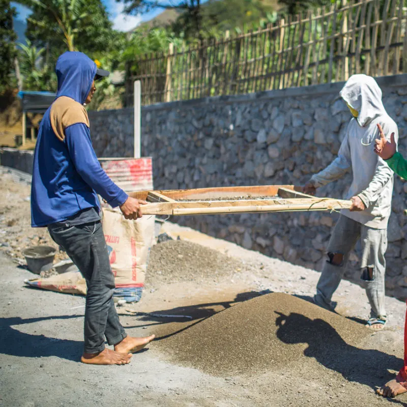 Construction-Workers-In-Bali-Sift-Sand-For-Concrete