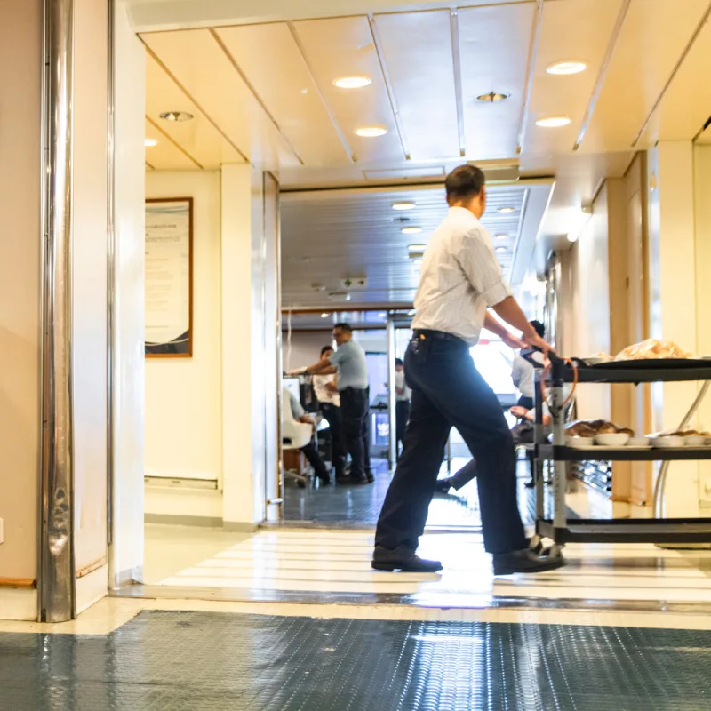 Cruise-Worker-Walks-Along-Corridor-