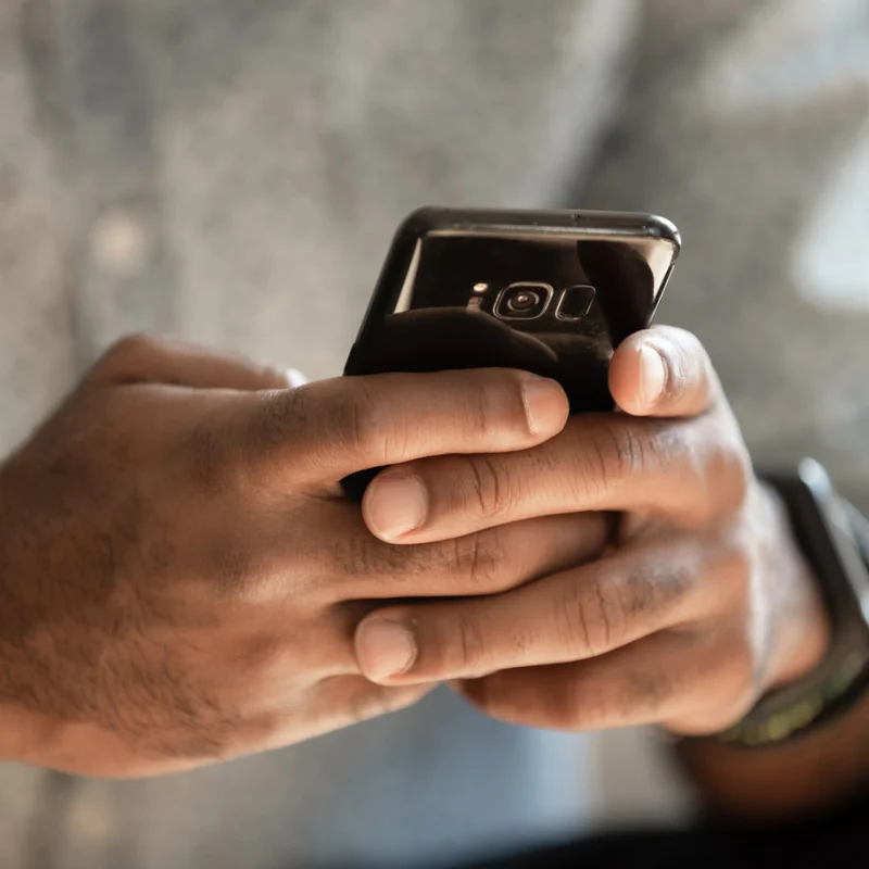 Hands holding a cell phone