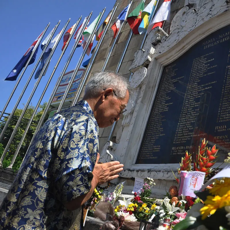 Man-Prays-At-The-Bali-Bombing-Memorial-In-Kuta