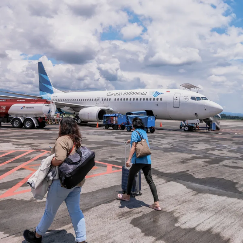 Passengers-Walk-In-Front-Of-Garuda-Indonesia-Plane-At-Airport-