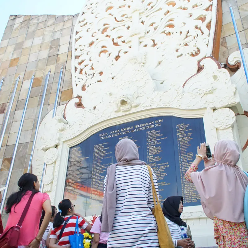 People-Stand-Beneath-The-Bali-Bombing-Memorial-In-Kuta-1