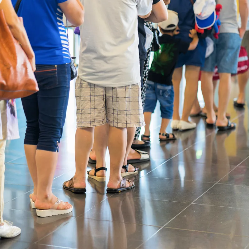 People-Stand-In-Queue-At-Airport