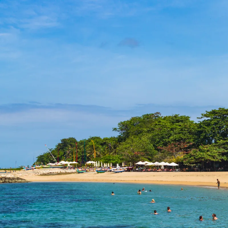 Sanur-Beach-And-Ocean-With-Tourists-Enjoying-The-Sun