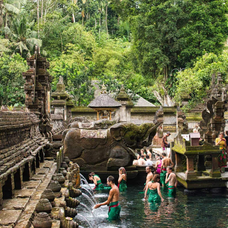 Tourists-Recieve-Water-Blessings-At-Bali-Temple