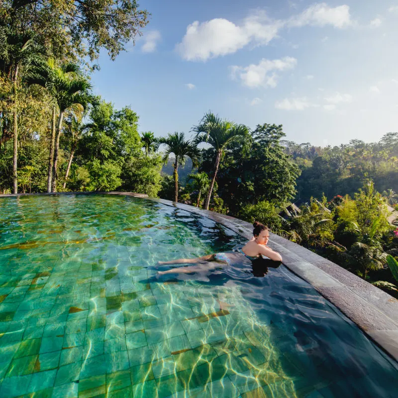 Woman-Poses-In-Bali-Resort-Swimming-Pool-In-Ubud-Jungle