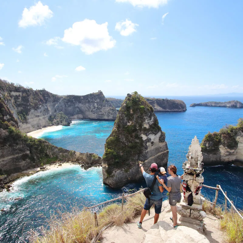 Young family look out over Nusa Penida viewing point