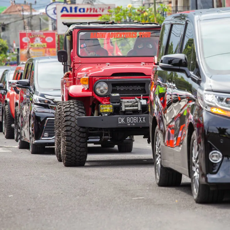 Bali-Car-Traffic-On-Normal-Busy-Street-In-The-Daytime