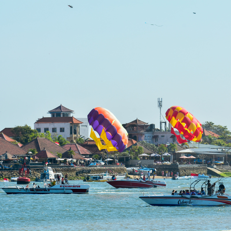 Benoa Tourist Harbor With Parasailing And Boats In Bali