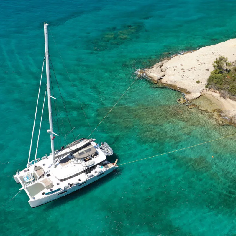 Catamaran Luxury Cruise Ship In Shallow Waters Off Bali Beach