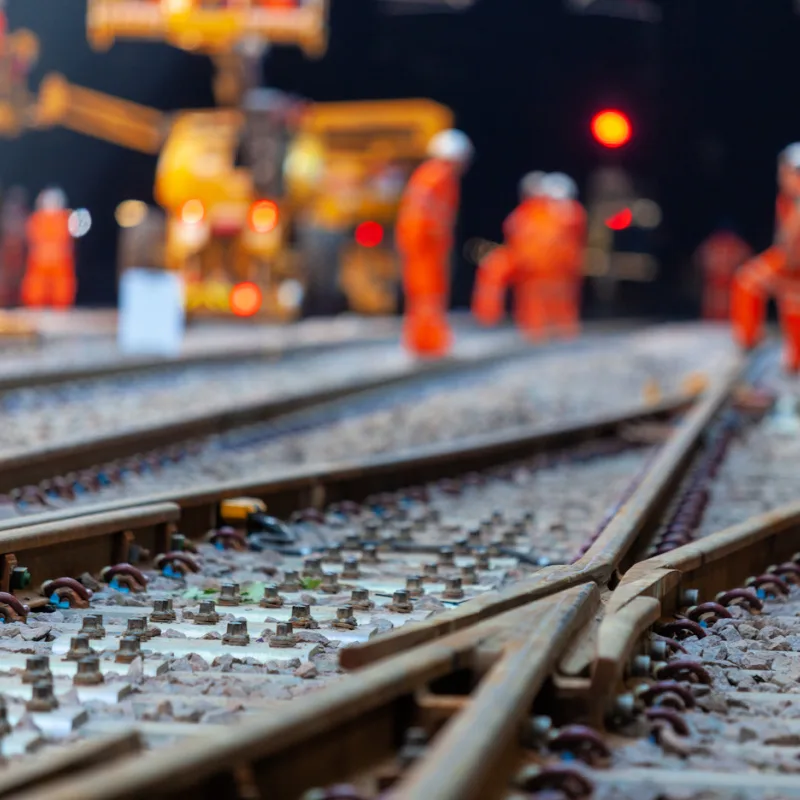 Construction-Workers-Wear-Orange-Uniforms-and-Work-on-Trainline