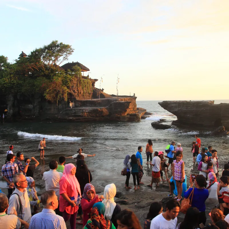 Domestic Tourist Explore Tanah Lot Temple At Sunset In Bali