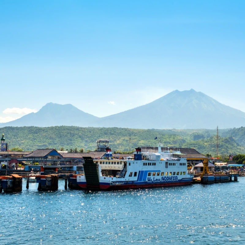 Boats in bali with mountain in background