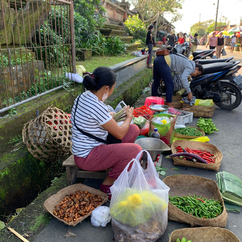 Market Vendor Sells Vegetables At Early Morning Street Market In Bali