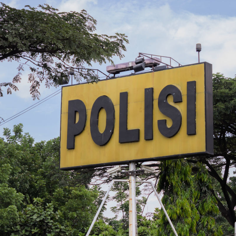 Police-Polisi-Sign-Board-Surrounded-By-Trees