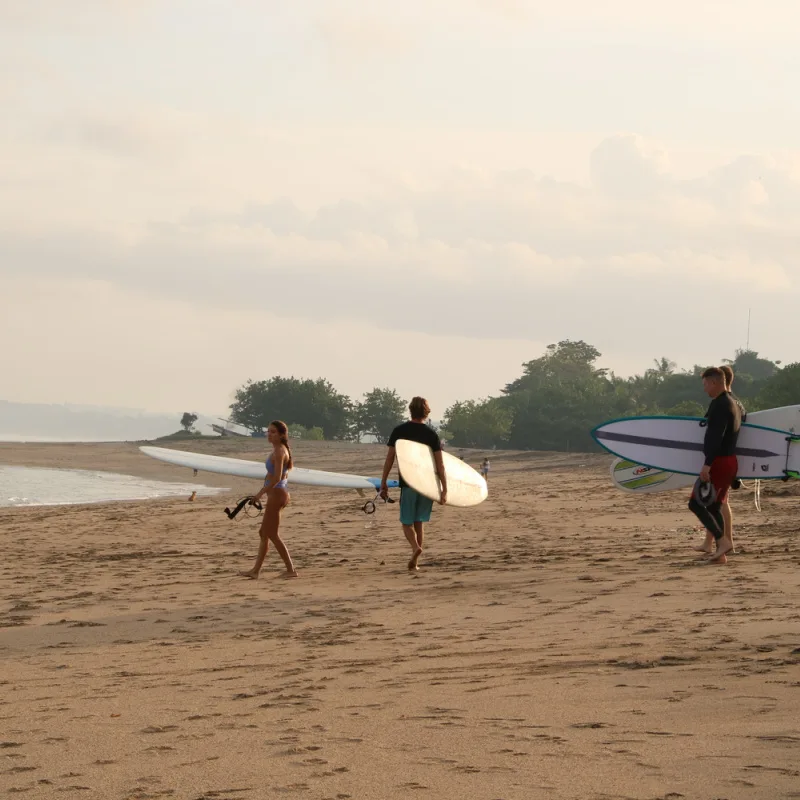 Surfers-Approach-The-Sea-At-Pantai-Jerman-Beach-In-Bali