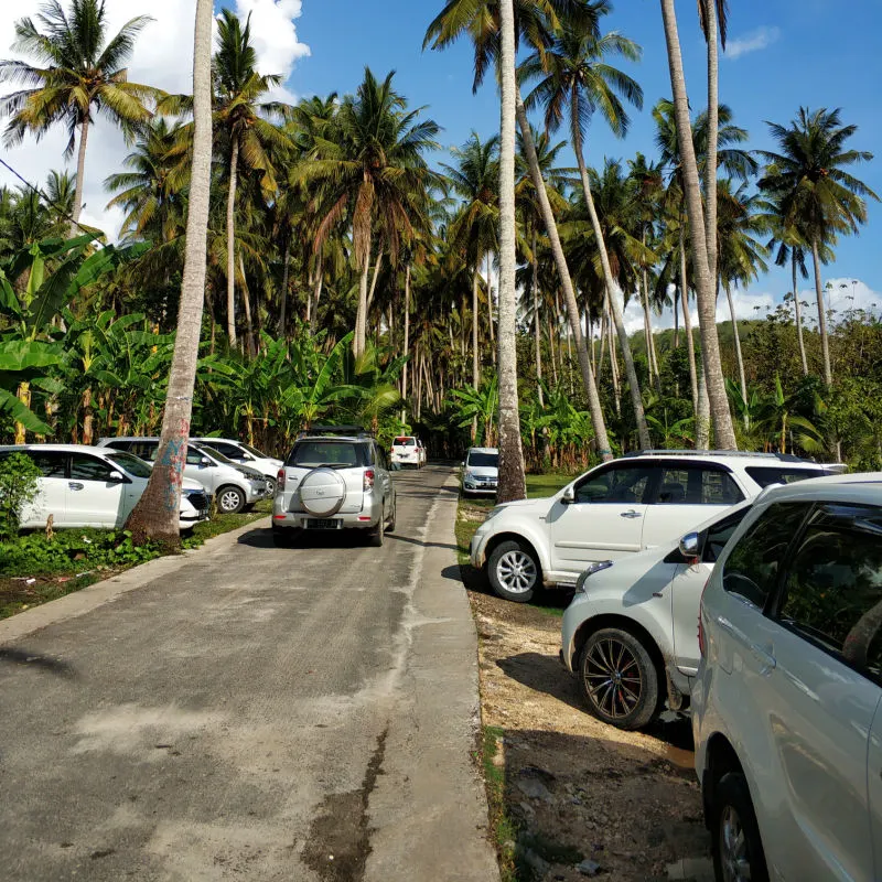 Taxi-Tourist-Cars-On-Village-Road-In-Nusa-Penida-Bali