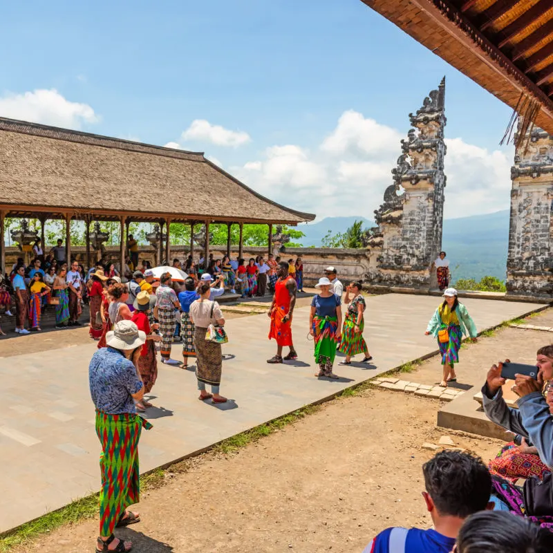 Tourists-Visitors-Stand-outisde-Gateway-to-Heaven-Temple-In-Bali