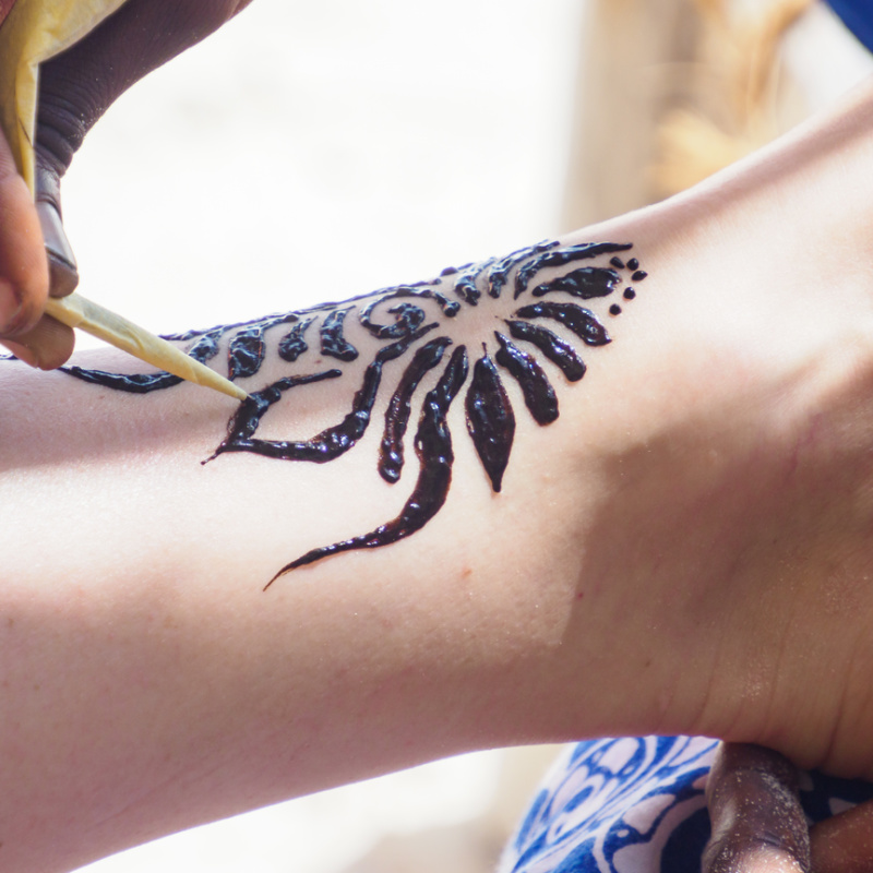 Tourist-Gets-Black-Henna-Tattoo-On-Bali-Beach