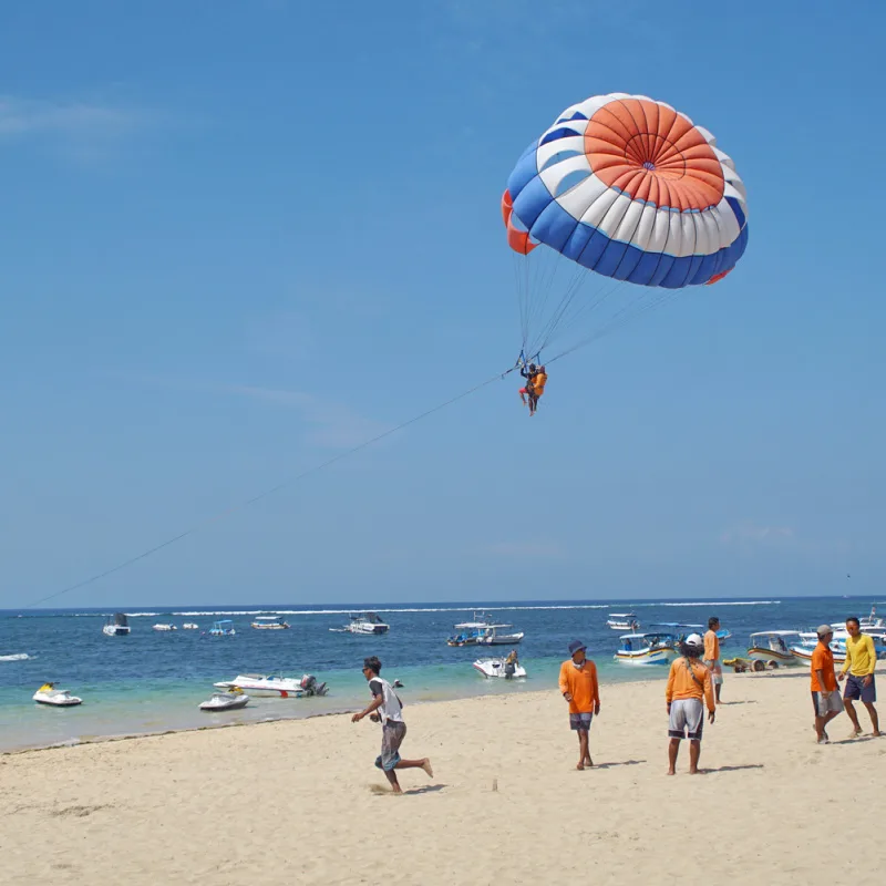 Tourists-Parasail-Off-Tanjung-Benoa-Beach-In-Bali