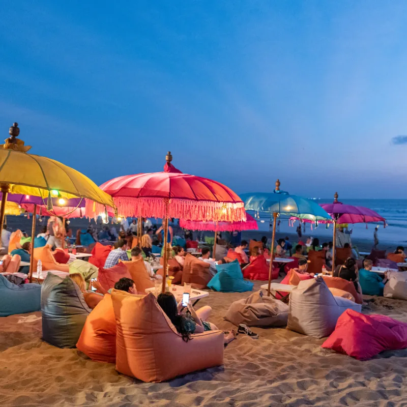 Tourists-Relax-In-The-Early-Evening-UNder-Umbrellas-At-Kuta-Beach