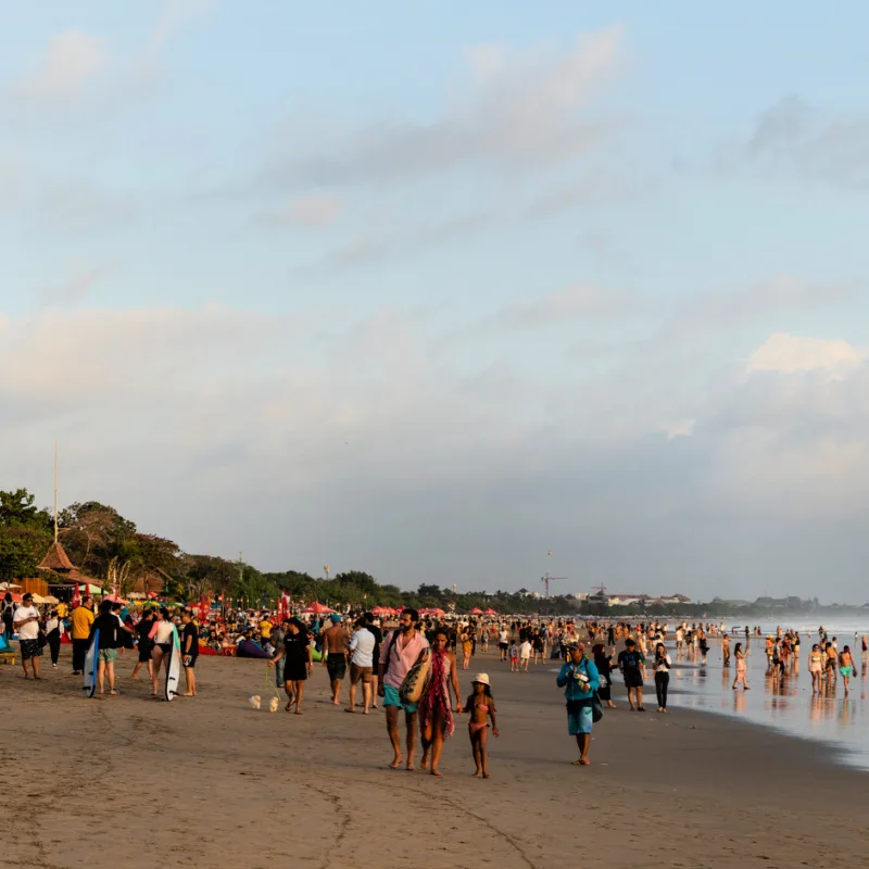 Tourists-Walk-Along-Seminyak-Beach-In-Bali