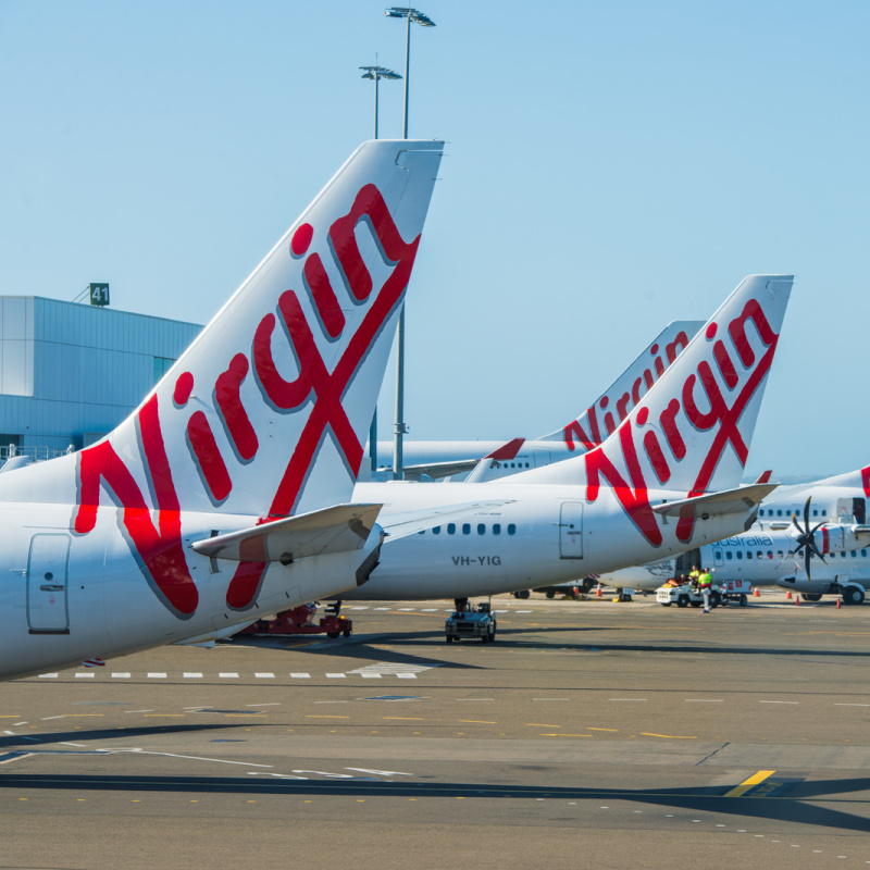 Virgin Australia Airplanes Line Up At Airport Terminal Building