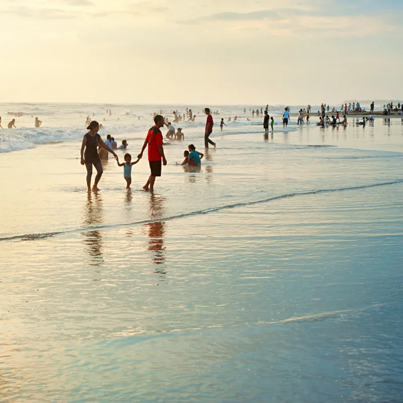 Young-Families-Enjoy-Sunset-In-The-Shoreline-Of-Bali-Kuta-Beach