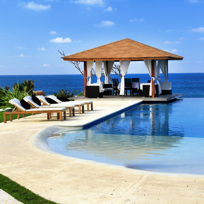 Bali Hotel Resort And Sun Deck Patio With Sun Loungers And Infinity Pool