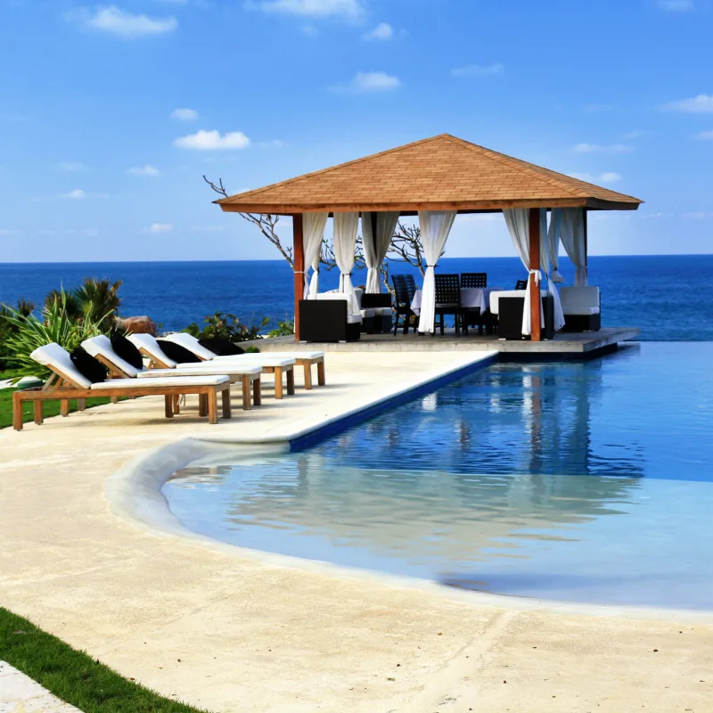 Bali Hotel Resort And Sun Deck Patio With Sun Loungers And Infinity Pool