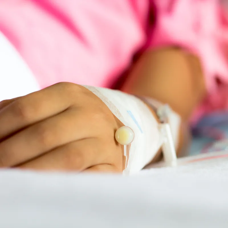 Close Up Of Child's Hand With An IV In Hospital