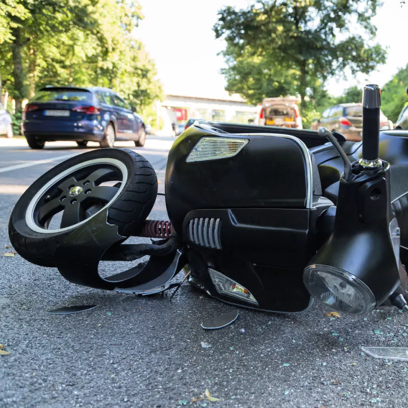 Close-Up-Of-Moped-That-Has-Crashed-In-Traffic-Accident-In-The-Road