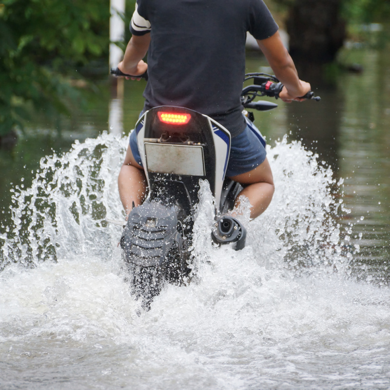 Indonesian Man Drives Moped Motorbike Through Flood Water