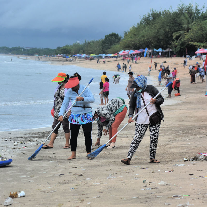 Local Women Clean Up Kuta Beach After Plastic Waste Washes Up On The Shoreline In Bali