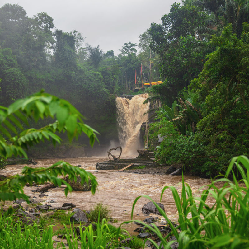 Muddy Flood Water Runs Down Waterfall In Bali