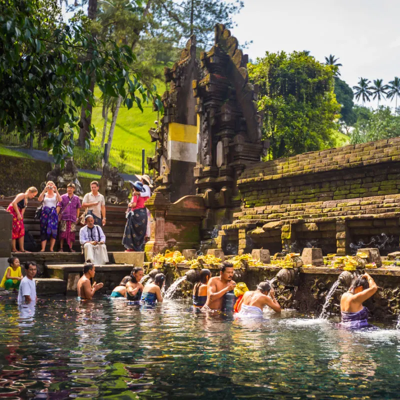 People Take Part In Traditional Bali Water Purification Ceremony at Temple.jpg