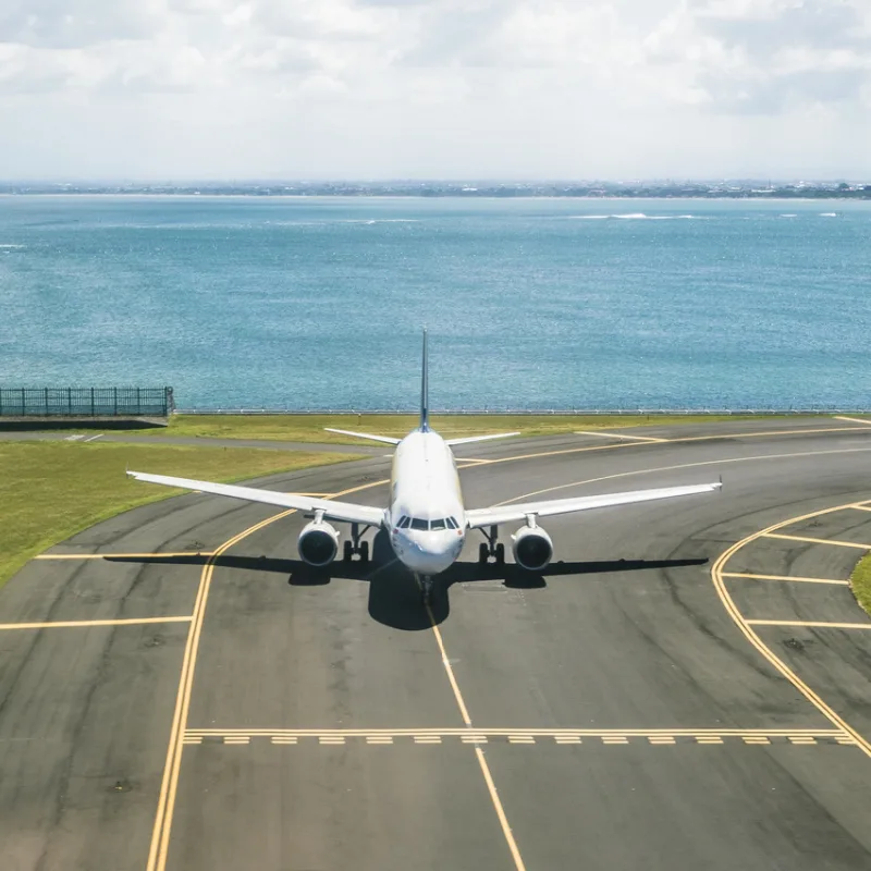 Plane Taxis At Bali Airport Close To The Sea