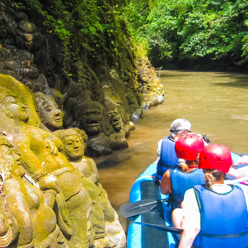Raft Carrying Tourists Along Ayung River Outside Of Ubud In Bali.