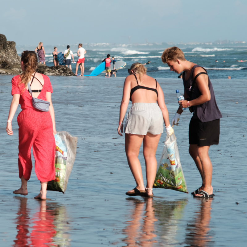 Tourists In Bali Help With Local Beach Clean Up Of Plastic Waste.