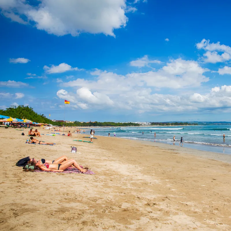 Tourists-Relax-On-A-Quiet-Kuta-Beach-in-Bali