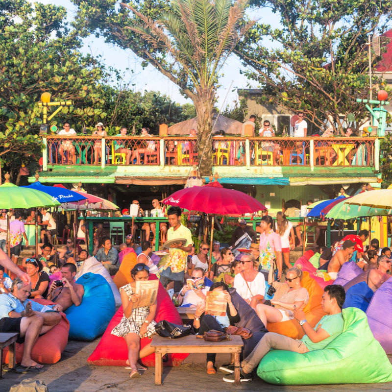 Travelers Enjoy Sunset Drinks In Legian Kuta Beach Bar
