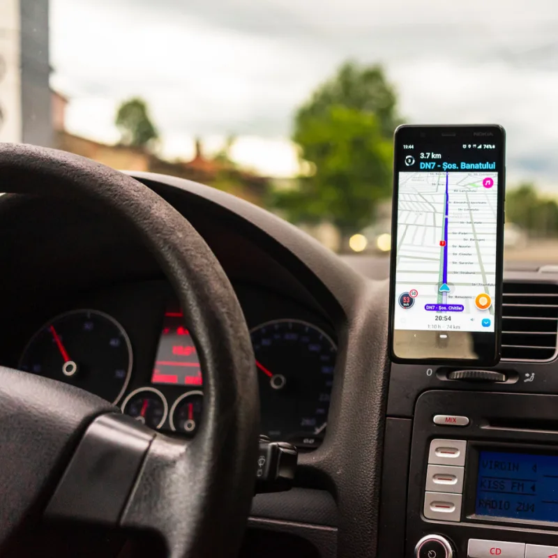 View Of Smartphone Cellphone On Dashboard of Car Following Google Maps