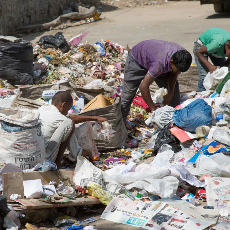 Waste Management Workers Sort Through Waste Garbage At Sorting Site