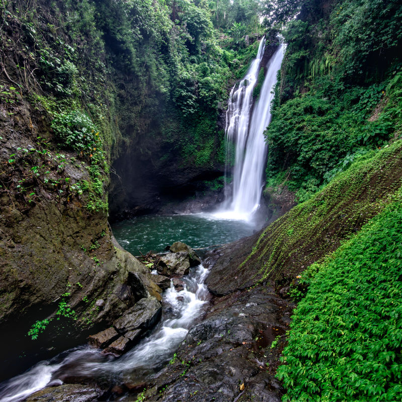 Aling Aling Waterfall Flows In Bali Surrounded By Jungle.