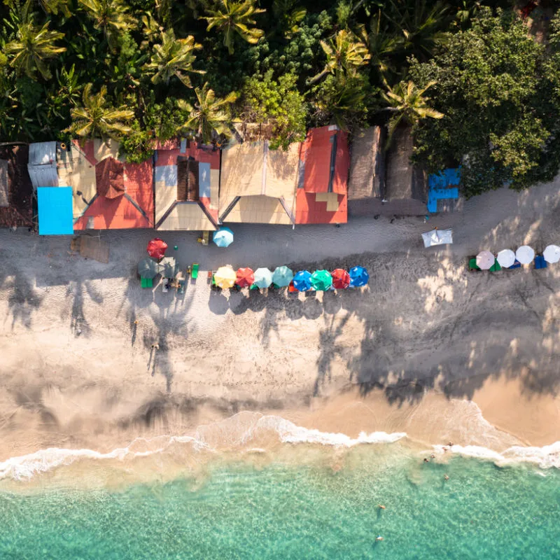 Ariel View Of Beach Shacks On Bali Beach