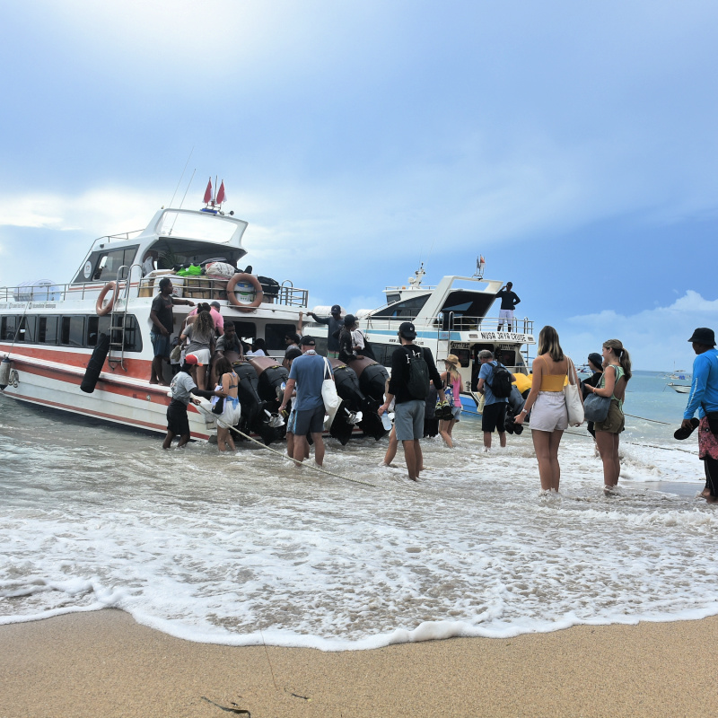 Bali tourists Get On Board Fast Boat At Sanur