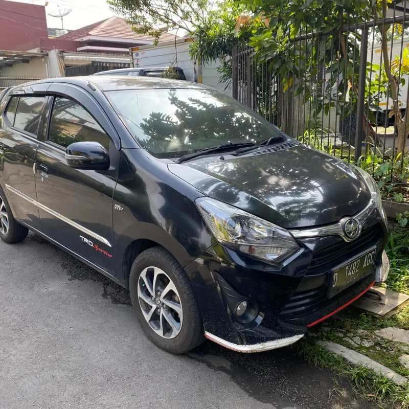Close Up Of Toyota Agya Black Car On Driveway In Bali