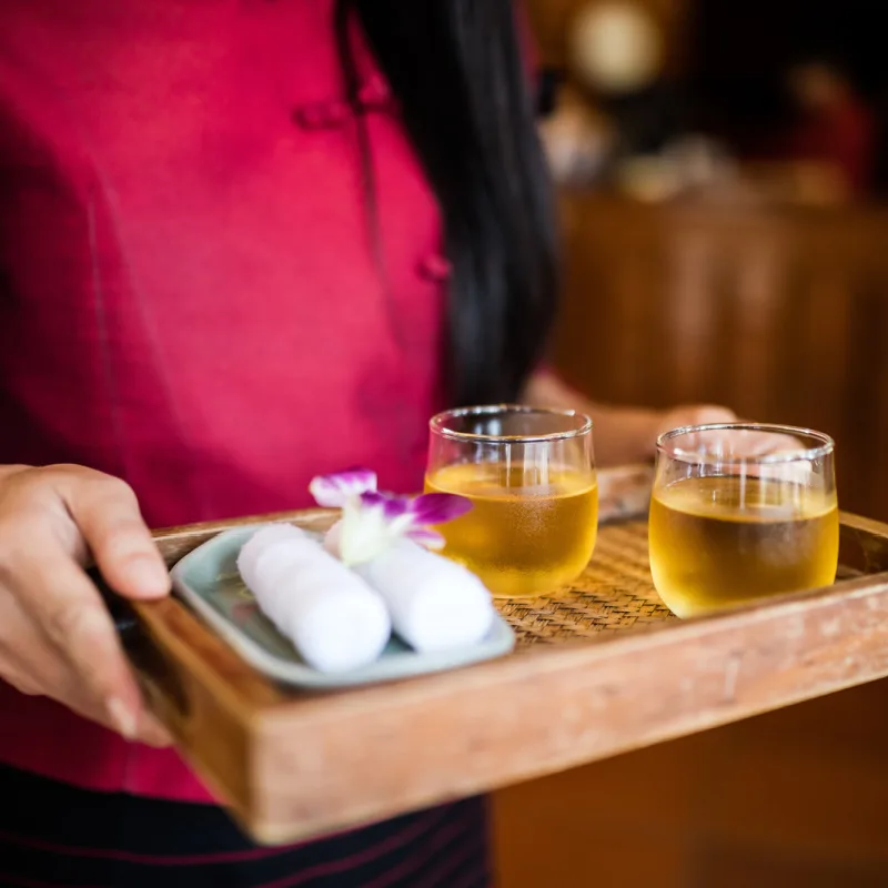Hotel Host Hold Tray Of Welcome Drinks in Bali