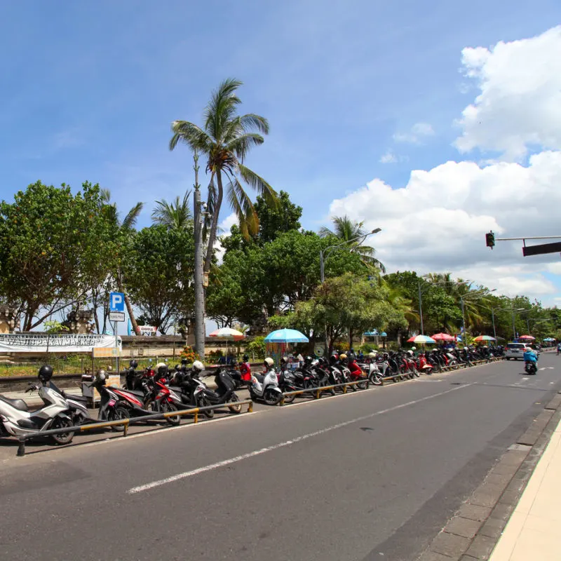 Jalan Pantai Kuta With Mopeds Parked in a Line