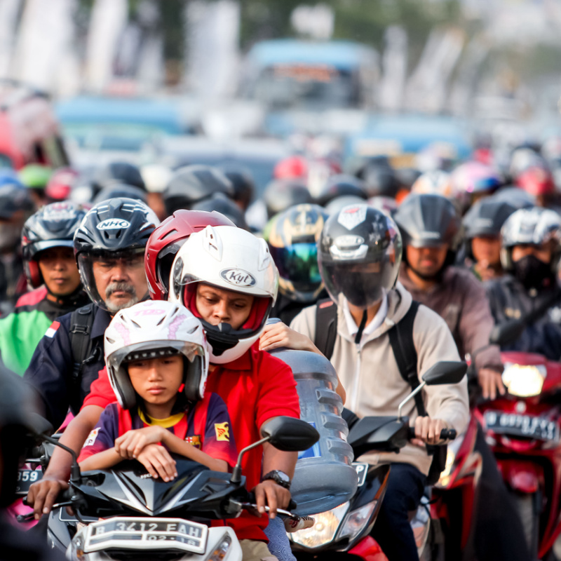 Moped Drivers Sit In Bali Traffic